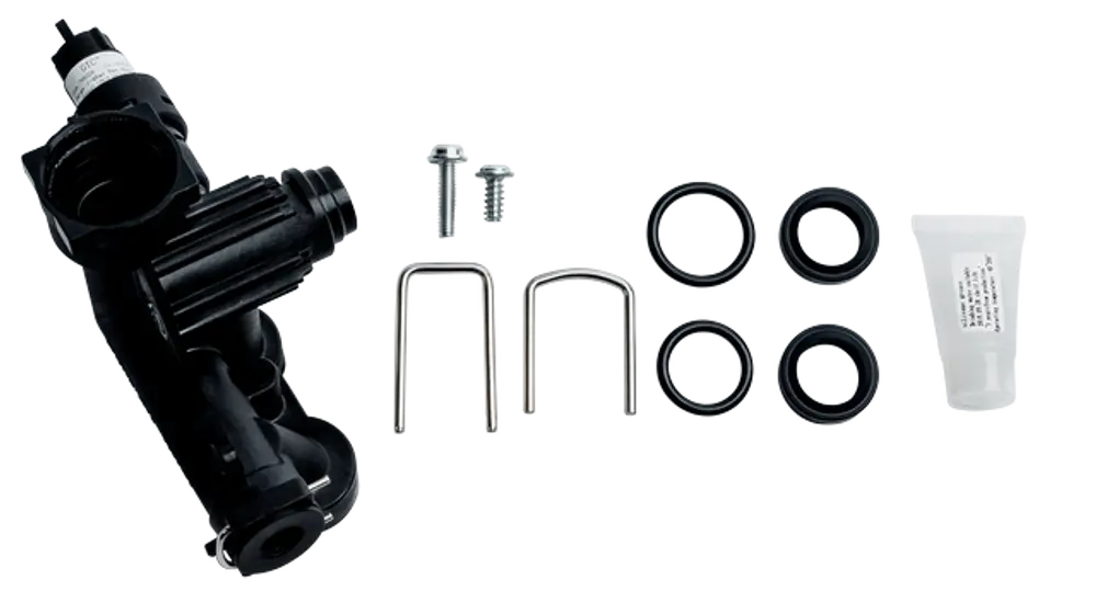 Montagesatz für hydraulische Systeme von Wolf, bestehend aus einer Hydraulikeinheit, Schrauben, Dichtungen und Montagegel in einem klaren Arrangement auf weißem Hintergrund.